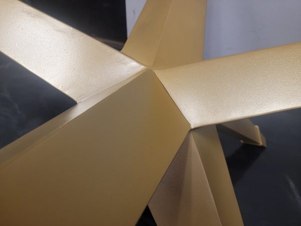 High end attention to detail on star shaped metal table base